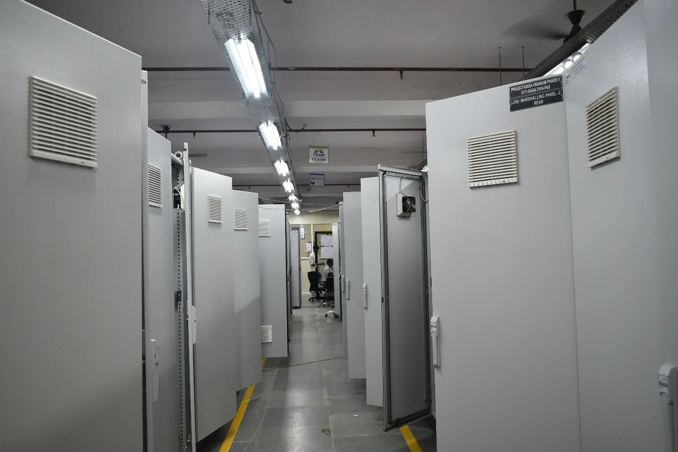 Factory aisle between manufactured marshalling panel cabinets